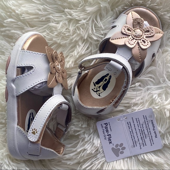 Hush Puppies Girls sandals in white and metallic gold. Velcro closure flowers